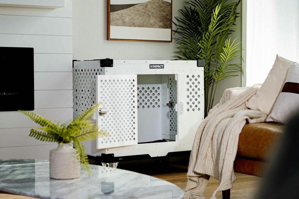 Sleek white dog crate in a warmly lit living room with natural elements.