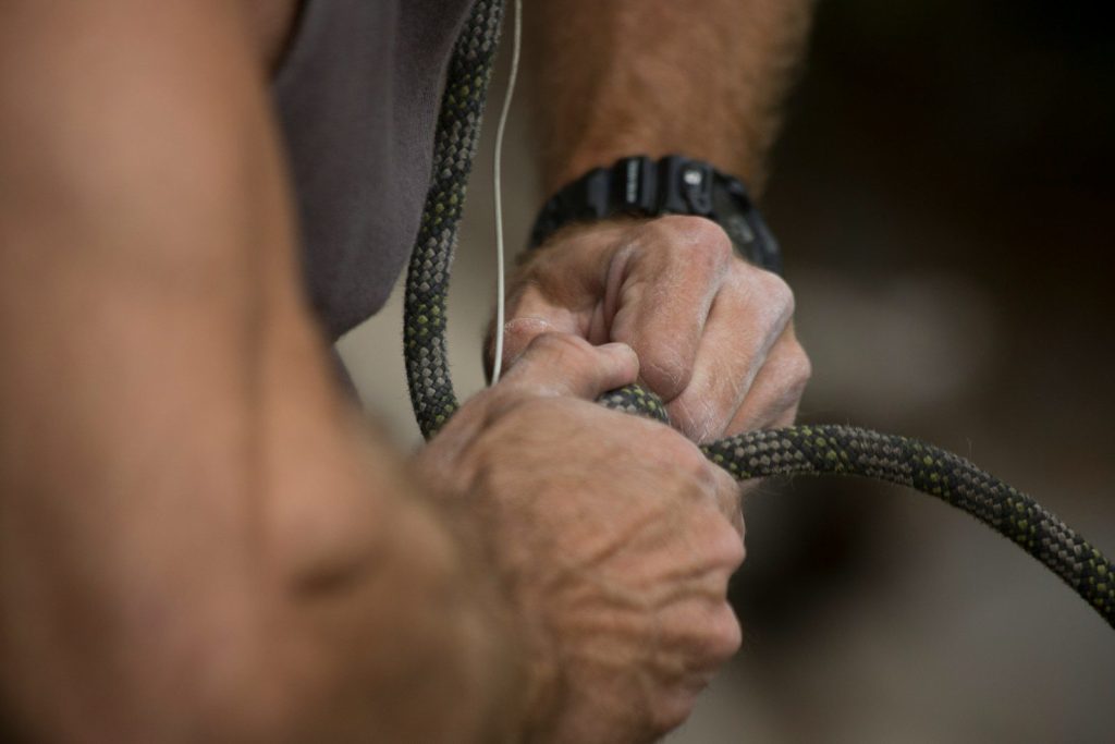 a close up of a person holding a hose