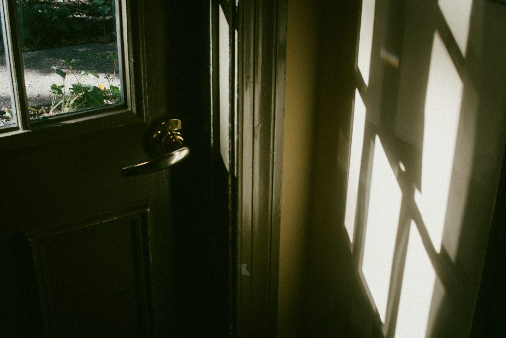 A hallway with a door and a window