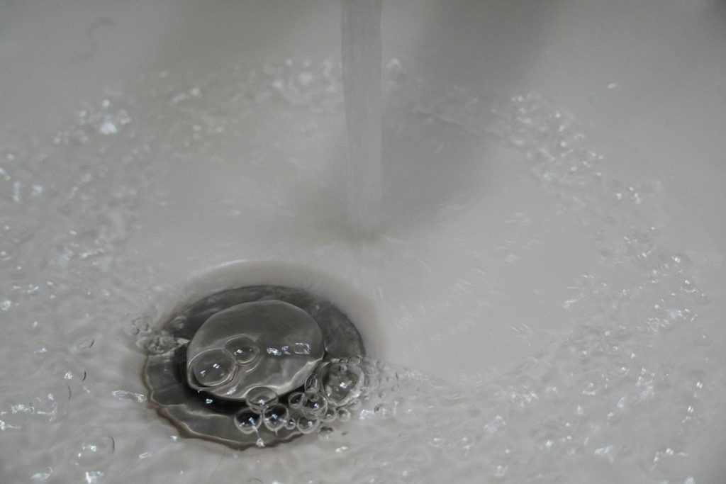 a close up of a sink with water running down it