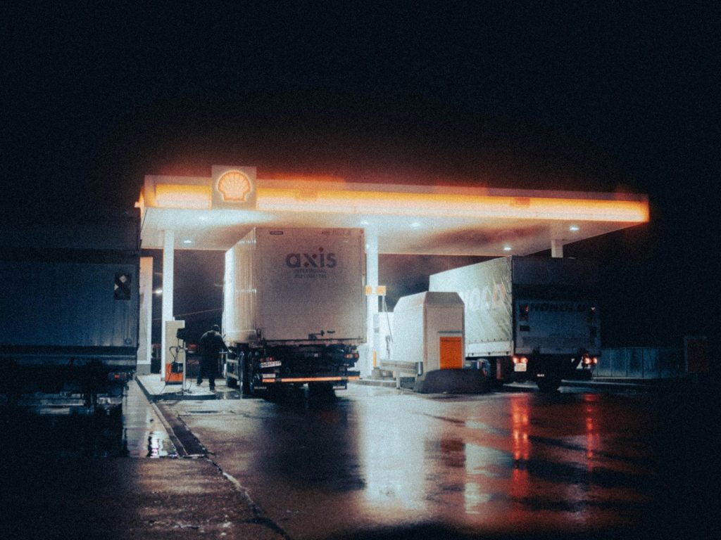 a gas station at night with lights on