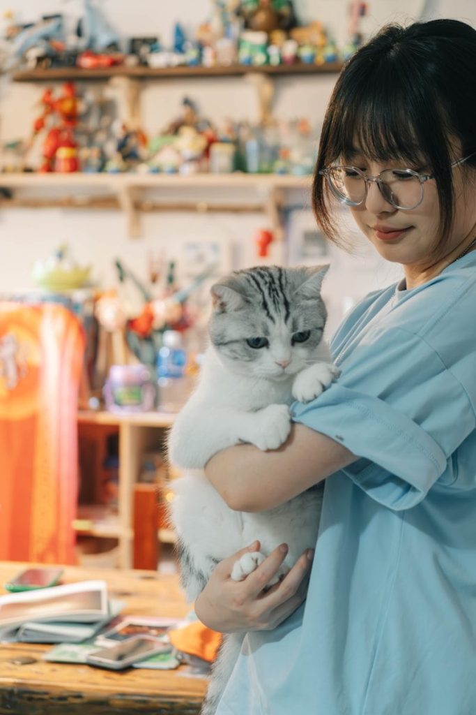 A woman holding a cat in her arms