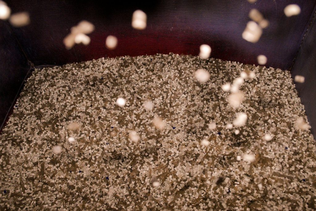 a pile of dirt sitting inside of a metal container