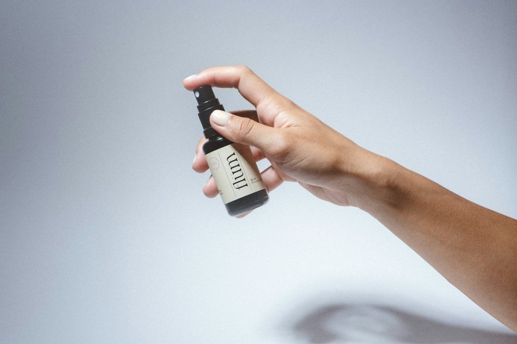 a hand holding a small black device