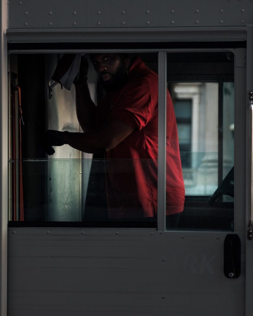 man in red top inside car