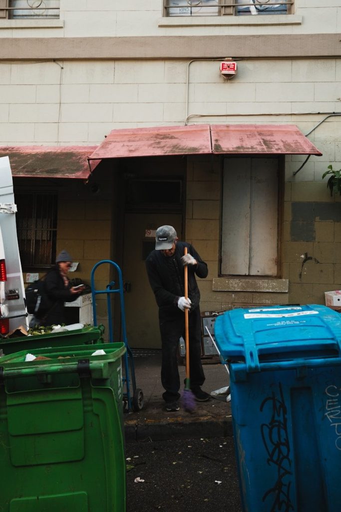 A group of garbage cans sitting in front of a building
