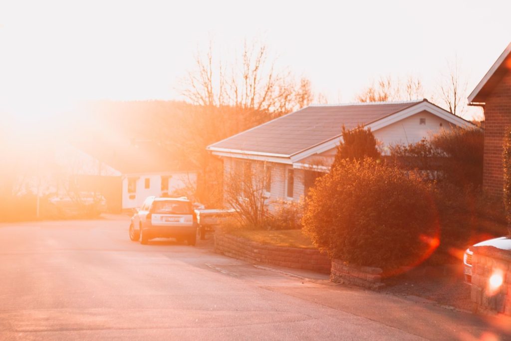 Warm sunset on a suburban street in Karlshamn, capturing cozy houses and peaceful ambiance.