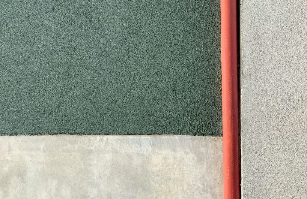 a close up of a wall with a red pole