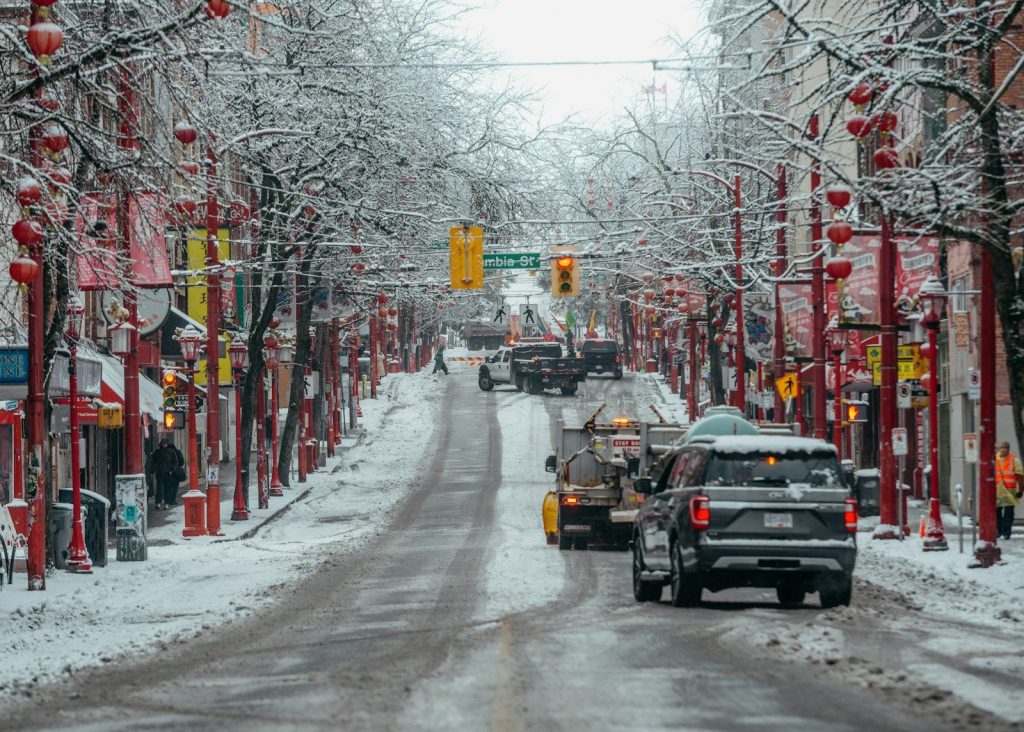 A car driving down a snow covered street